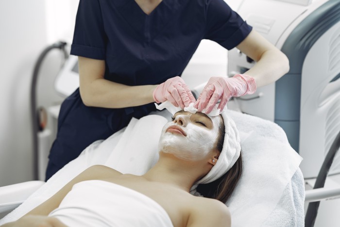 Woman receiving professional facial treatment from the best dermatologist in Sector-74 Noida